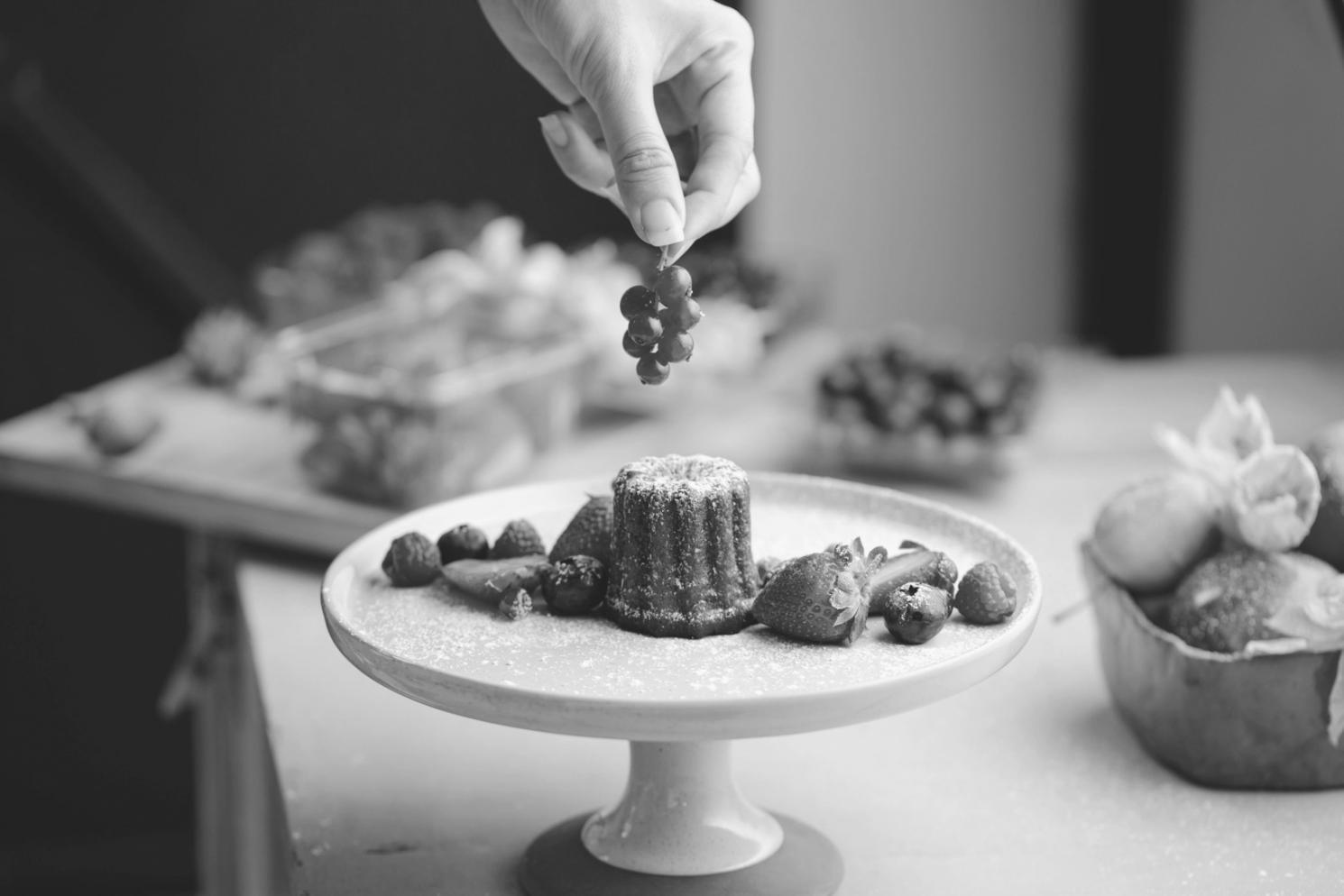 Students preparing colorful dishes in a professional kitchen with chef supervision